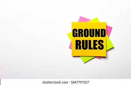 On a light background - bright multicolored stickers with the text GROUND RULES. Copy space