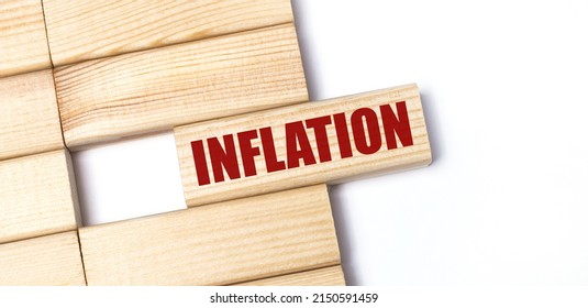 On a light background, wooden blocks with the text INFLATION. Close-up top view. - Shutterstock ID 2150591459