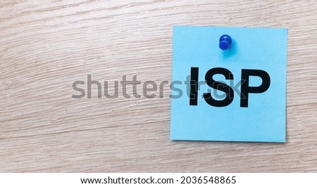 On a light wooden background - a light blue square sticker with the text ISP Internet Service Provider
