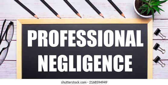 On A Light Wooden Table - A Board With The Text PROFESSIONAL NEGLIGENCE, Pencils, Plants, Glasses And Paper Clips. Business Concept