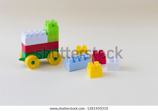 on a light yellow background the car is made of\
cubes. Free space for text