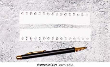 On a marble background, two torn strips of white paper with space for inserting text and a black pen. Copy space