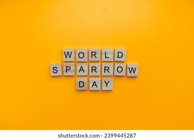 On March 20, World Sparrow Day, a minimalistic banner with an inscription in wooden letters - Powered by Shutterstock