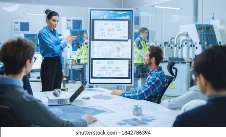 On a Meeting: Confident Female Engineer Talks to a Group of Specialists, Managers, Uses Interactive Digital Whiteboard to Show New Eco Friendly Engine Concept. Sustainable Green Energy Research