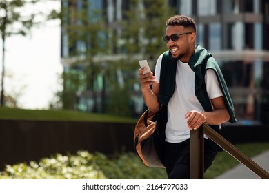 On My Way To Work. Happy Stylish African American Man Using His Smartphone And Walking In Park Area, Texting On Phone And Smiling, Panorama With Free Space