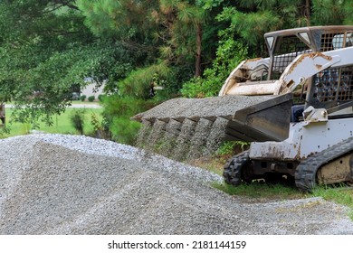 On A New Road Reconstruction Project, Bobcat Tractor Transports And Unloads Gravel