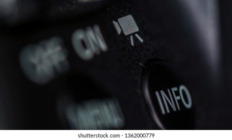 The on and off button of the camera on a macro shot with other buttons on the back