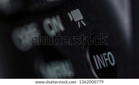 The on and off button of the camera on a macro shot with other buttons on the back