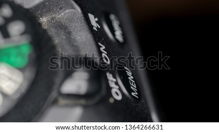 The On and Off buttons of the camera on a macro shot with the other buttons on the side