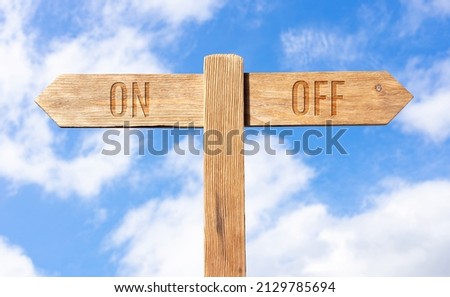 On or Off concept. Wooden signpost with message on sky background