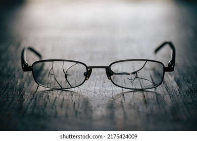 On An Old, Wooden Background, Men's Glasses With Cracked Glasses, Studio Photography, Close-up.