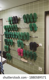 on an operating room corridor there is a wall with surgical shoes for the staff