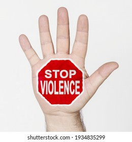 On the palm of the hand there is a stop sign with the inscription - STOP VIOLENCE. Isolated on white background.