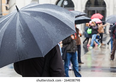 On A Rainy Day With Rain Umbrella In The City