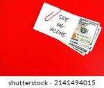 On red copy space background, dollars cash money with text note SIDE GIG IMCOME, financial planning - make more money or extra earning from part time side hustle, second job to increase income