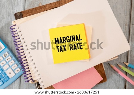 on a red notepad a sheet of paper with text Marginal tax rate