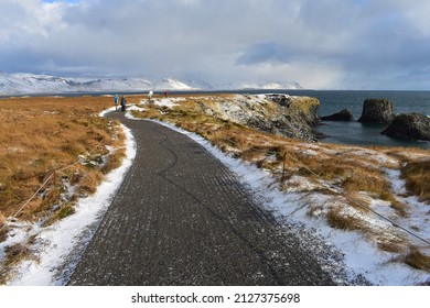 On the road again. breathtaking landscape snow and sea, golden grass and basalt stones in Iceland remote travel