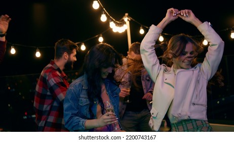 On The Rooftop Of Terrace Group Of Friends Have Fun Time Dancing And Feeling Happy At The Party Night Time They Drinking Champagne