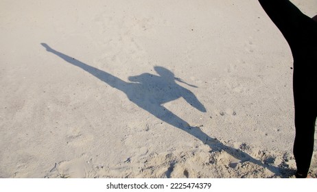 On the sand you can see the shadow, the silhouette of an athletic girl, who performs lifting of the legs, fulfills the kicks, trains to fight, the fight with the shadow. Slow motion. High quality - Powered by Shutterstock