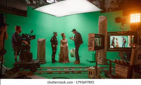 On Set: Director Explains Scene To Woman Actress Playing Renaissance Lady And Actor Wearing Motion Capture Suit. On Big Film Studio Professional Crew Shooting Period Costume Drama Movie.