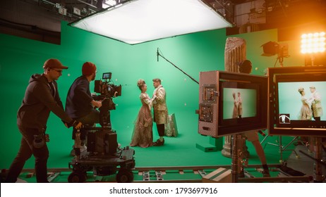 On Set: Famous Female Director Controls Cameraman Shooting Green Screen Scene With Two Actors Talented Wearing Renaissance Clothes Talking. Crew Shooting Period Costume Drama Movie.