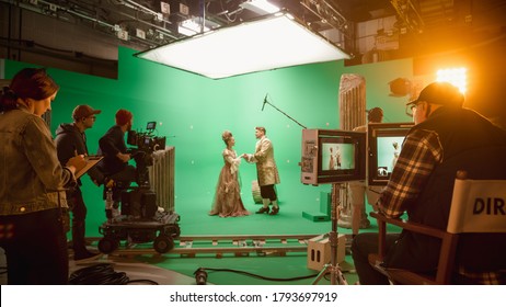 On Set: Famous Female Director Controls Cameraman Shooting Green Screen Scene With Two Actors Talented Wearing Renaissance Clothes Talking. Crew Shooting Period Costume Drama Movie.