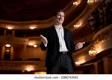 On Stage. Man In Black Formal Suit Tuxedo Performing Startup CEO Presents New Product, Does Motivational Talk, And Lecture About Science, Technology, Entrepreneurship, Development, Leadership.