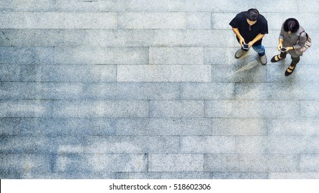 On Street Of Top View People Play And Talk With The Smart Phone On The Concrete Pedestrian (Aerial View)