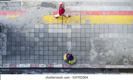On Street Walk In Top View Man And Woman With Shopping Bags Stand On Square Block Pedestrian Walk Way With Yellow And Red Line For Guide Blind People Walk (aerial City Street View)