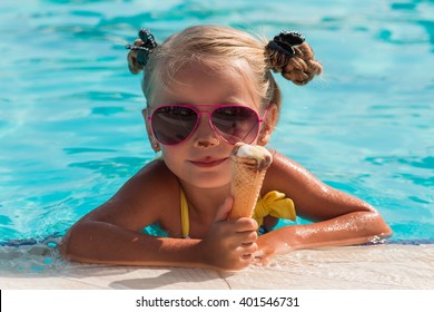 on a sunny day the girl in sunglasses with ice cream relaxing in the pool
 - Powered by Shutterstock