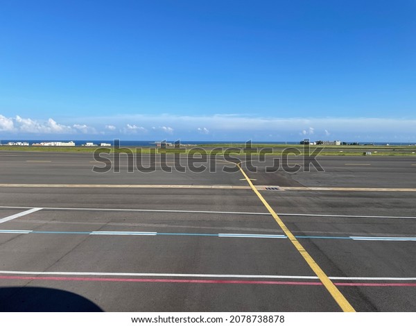 On a sunny day, a\
runway at the airport.