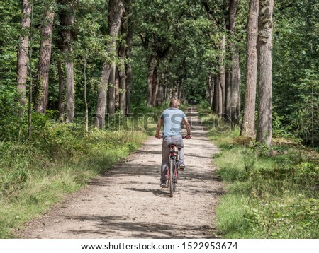 Similar – Radfahrer auf Waldweg