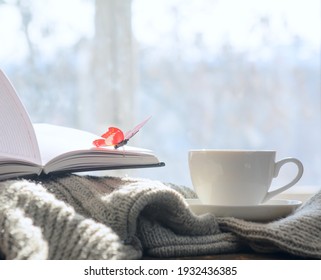On the sweater is a diary on which sits a butterfly. There is a cup of coffee next to it. Against the background of a spring window. Copy space. Concept-breakfast, business. - Shutterstock ID 1932436385