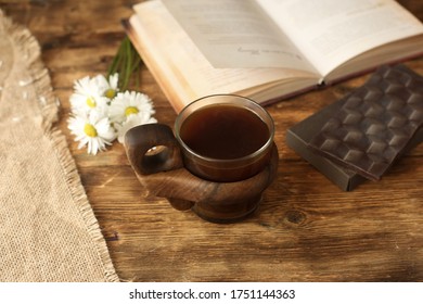On The Table Is A Beautiful Cup Of Coffee With Chocolate, A Book, Flowers. Paleo Or Keto Diet. Keto
Chocolate