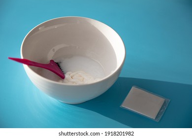 On The Table Is A Bowl With Hair Dye And A Brush. Home Coloring Concept.