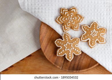 On the table is a delicious traditional ginger cookie in the shape of snowflakes.