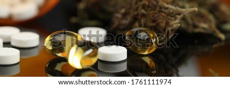 On table are hemp tablets and vegetable capsules. Wide range cannabis products with varying levels essential psychoactive substance. Reliable product information. Intensity effect when used