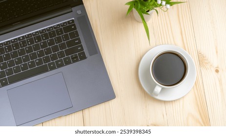 On the table is an open laptop, and next to it is a cup of hot coffee. This means that work and leisure can be together. My laptop says I need to work, and my coffee says I need to rest. - Powered by Shutterstock