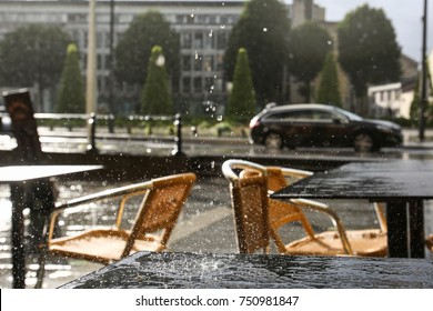 On The Table In Summer Cafe Dripping Rain In The Background Of The City