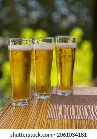 on the table are three glasses with cold beer next to each other