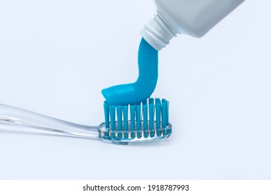 On The Toothbrush, Squeeze Out The Toothpaste On A White Background.