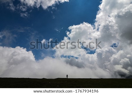 Similar – Image, Stock Photo Four people standing in a row on a ridge (2/2)