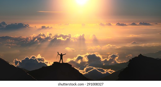 On The Top Of The World. A Man Standing On The Top Of The Mountain Above The Clouds. 