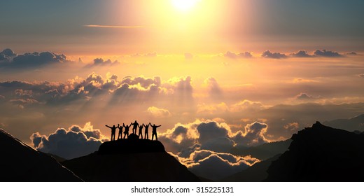 On the top of the world together. A group of people stands on a hill over the beautiful cloudscape. - Powered by Shutterstock