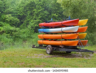 On The Trailer With Eight Canoes, Kayaks By Car Delivered To The River