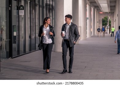 On The Way To Work. Portrait Of Two Smiling Business People Talking To Each Other While Walking On The Street.