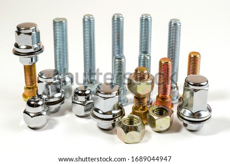 on a white background closeup new shiny car nuts and bolts