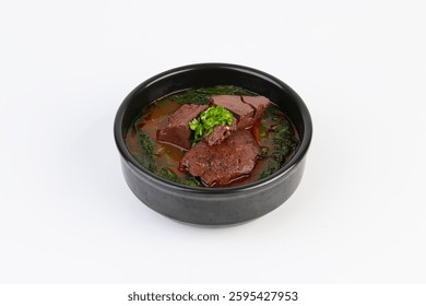 On a white background, inside an earthen pot, Spicy Korean Beef Soup