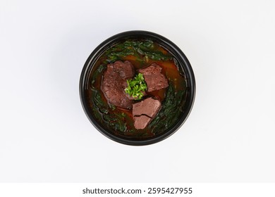 On a white background, inside an earthen pot, Spicy Korean Beef Soup