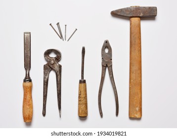 on a white background old often used hand tools hammer and nippers, pliers nails and chisel. flat lay. copy space. - Powered by Shutterstock